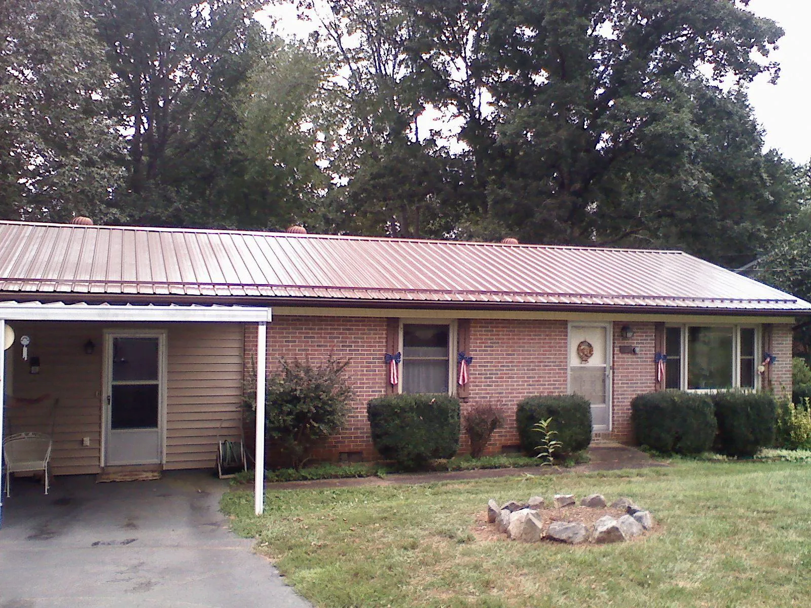 Bronze metal roof and carport on a brick ranch home — Roof Repair work by our crew in Colleyville
